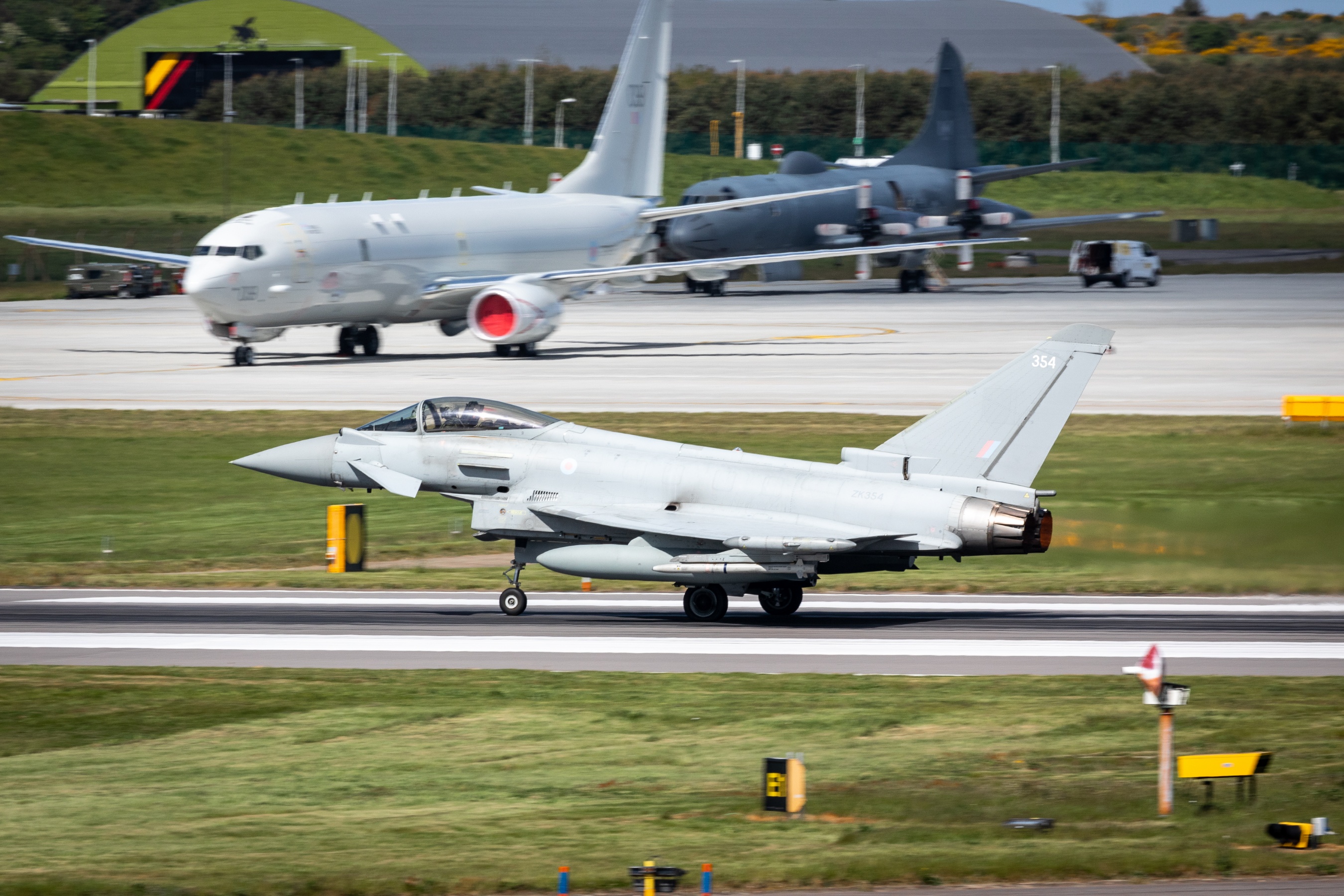 Typhoon taking off, with Atlas carrier aircraft in background.